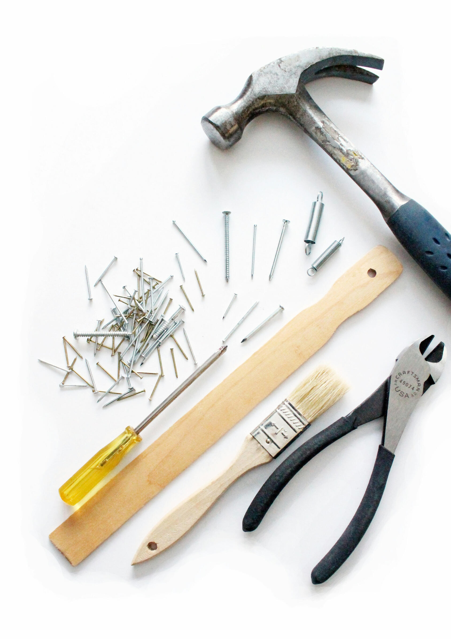 Hammer, nails, screw driver, paint brush Photo by Julie Molliver on Unsplash
